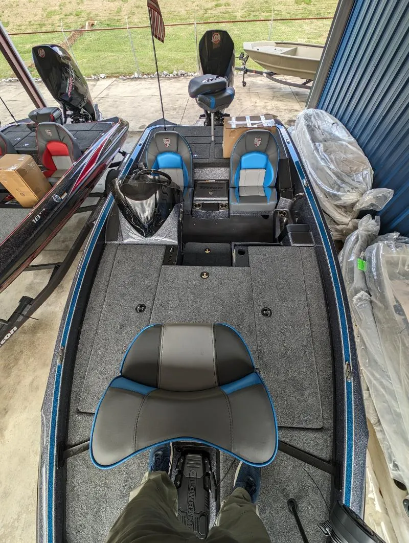 Slide: The Image of 2024 Triton 18 TrX fishing boat interior with seating and storage compartments. - 15