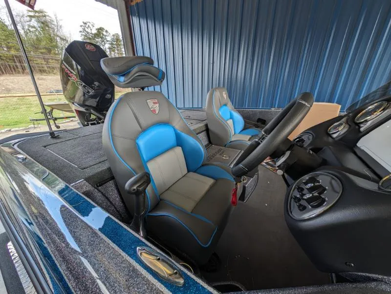 Slide: The Image of 2024 Triton 18 TrX boat interior with blue and gray seats. - 16