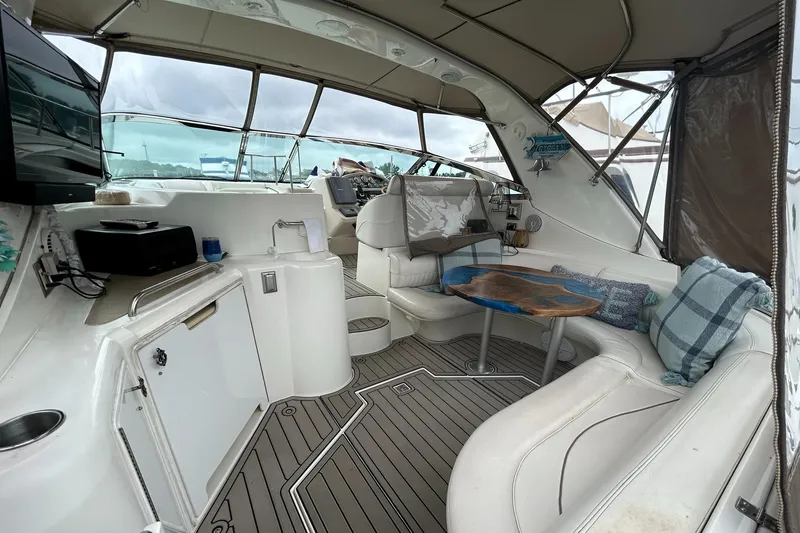 Slide: The Image of 2000 Cruisers Yachts 3870 Express interior with seating, table, and helm station. - 10