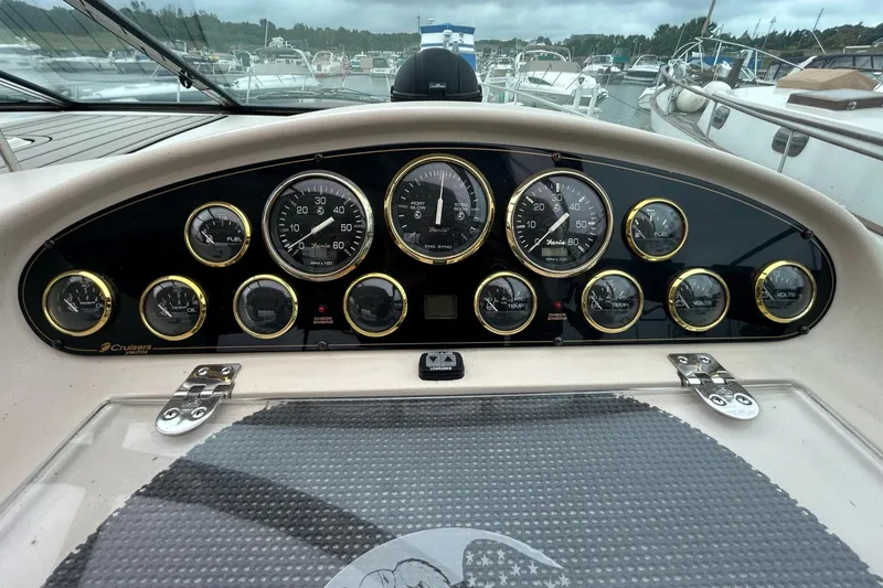 Slide: The Image of Dashboard of a 2000 Cruisers Yachts 3870 Express with various gauges and controls. - 12