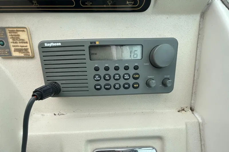 Slide: The Image of Raytheon marine radio on 2000 Cruisers Yachts 3870 Express dashboard. - 16
