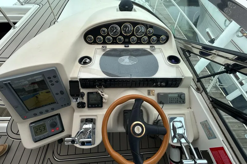 Slide: The Image of Helm of 2000 Cruisers Yachts 3870 Express with navigation instruments and wooden steering wheel. - 19