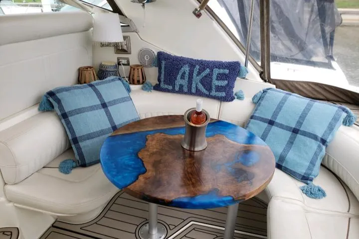 Slide: The Image of Cozy seating area on a 2000 Cruisers Yachts 3870 Express with lake-themed decor. - 2