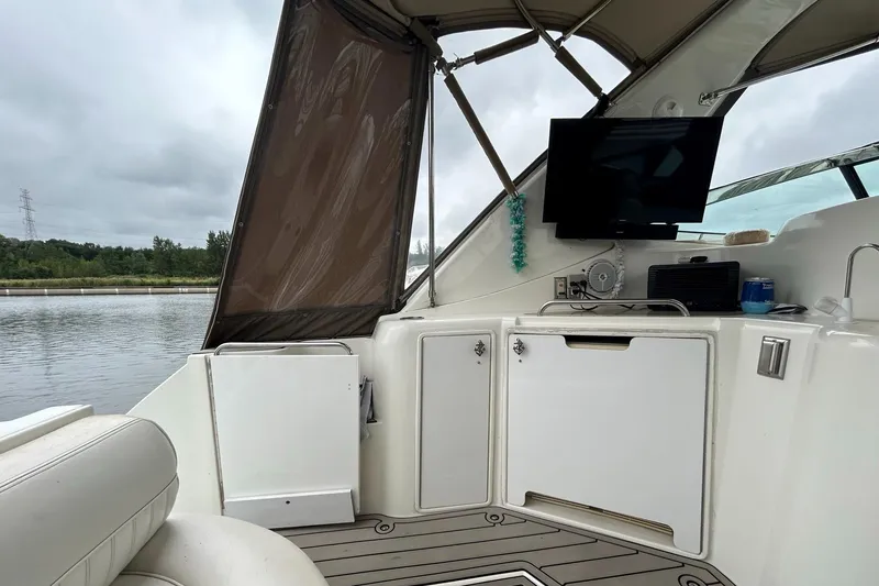 Slide: The Image of 2000 Cruisers Yachts 3870 Express cockpit with TV and storage cabinets. - 27