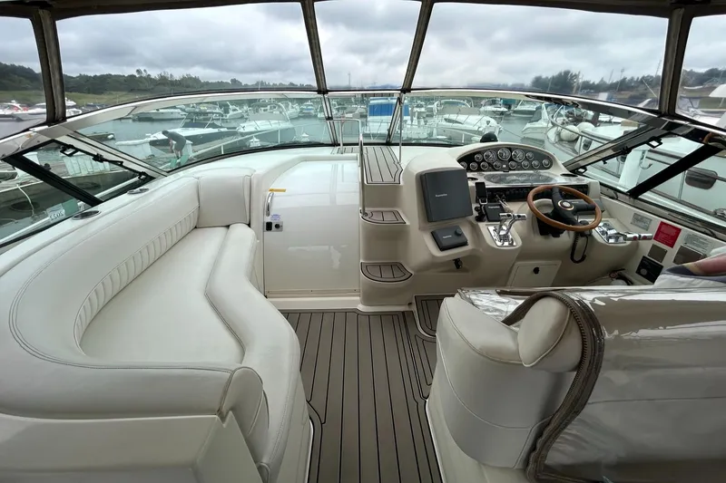Slide: The Image of 2000 Cruisers Yachts 3870 Express cockpit with helm, seating, and navigation controls. - 33