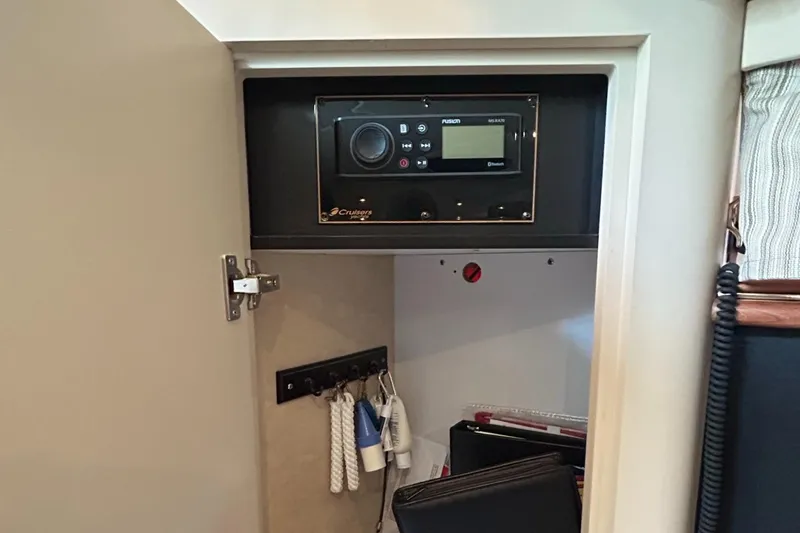 Slide: The Image of Cruisers Yachts 3870 Express 2000 model control panel inside a cabinet. - 35