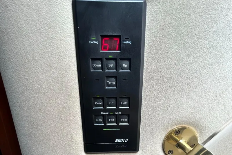 Slide: The Image of Cruisers Yachts 2000 3870 Express SMX II thermostat control panel displaying 67 degrees. - 37