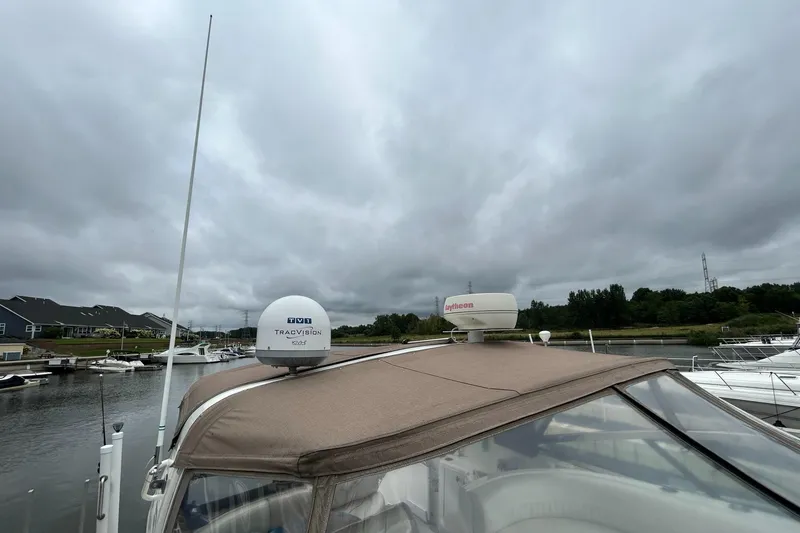 Slide: The Image of 2000 Cruisers Yachts 3870 Express docked under cloudy skies. - 38