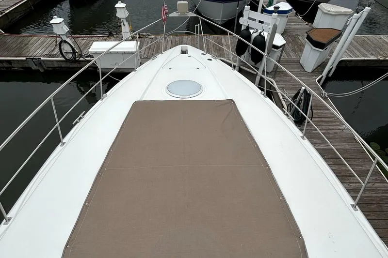 Slide: The Image of 2000 Cruisers Yachts 3870 Express bow view at marina dock. - 42