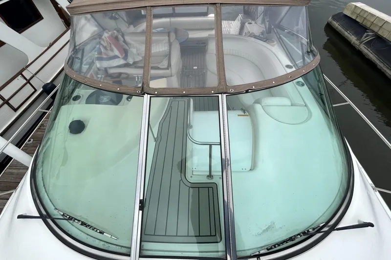 Slide: The Image of 2000 Cruisers Yachts 3870 Express boat with enclosed cockpit and seating area. - 44