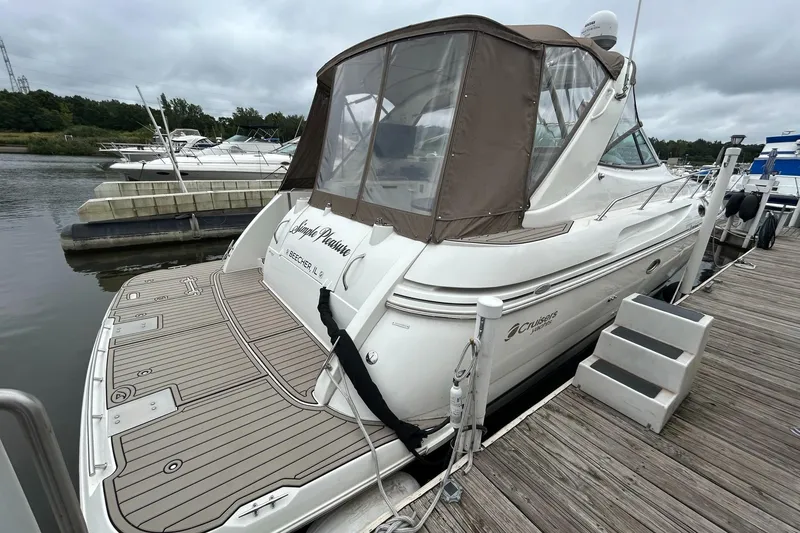 Slide: The Image of 2000 Cruisers Yachts 3870 Express docked at marina, rear view. - 47