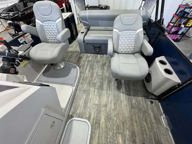 Slide: The Image of 2023 Crest Classic Platinum 220 boat interior with gray seating and modern design. - 11