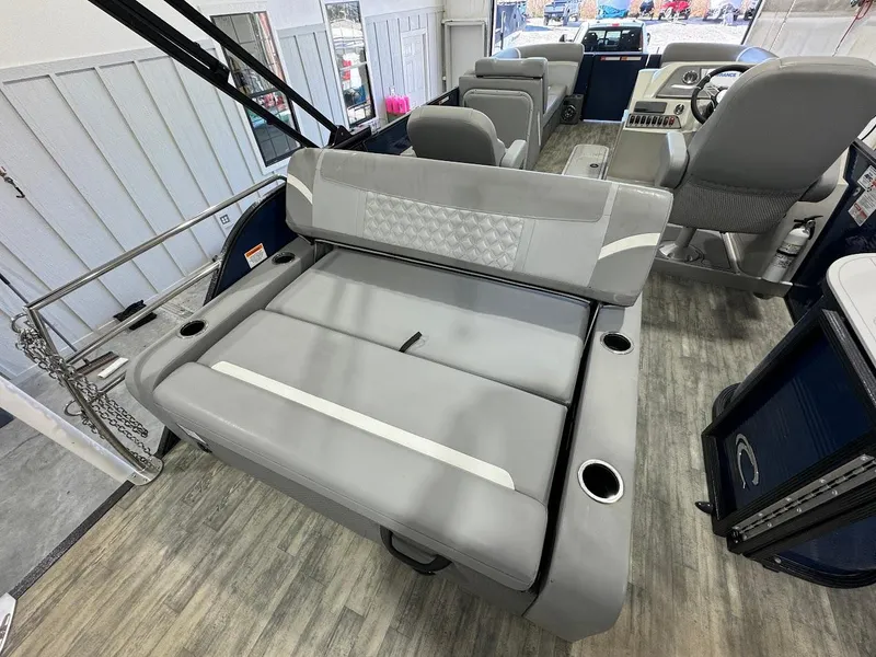 Slide: The Image of 2023 Crest Classic Platinum 220 boat interior with gray seating and cup holders. - 12