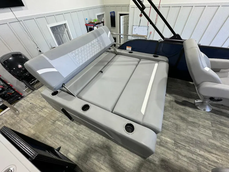 Slide: The Image of 2023 Crest Classic Platinum 220 boat interior with gray seating and cup holders. - 13