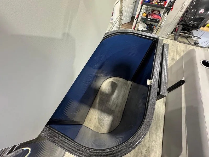 Slide: The Image of 2023 Crest Classic Platinum 220 boat interior storage compartment with blue lining. - 15