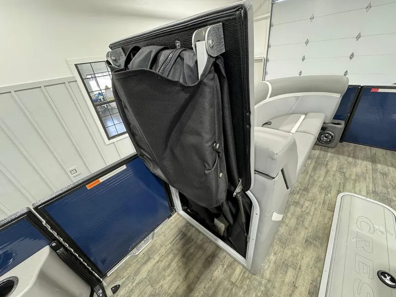 Slide: The Image of 2023 Crest Classic Platinum 220 interior with folded seat storage feature. - 16