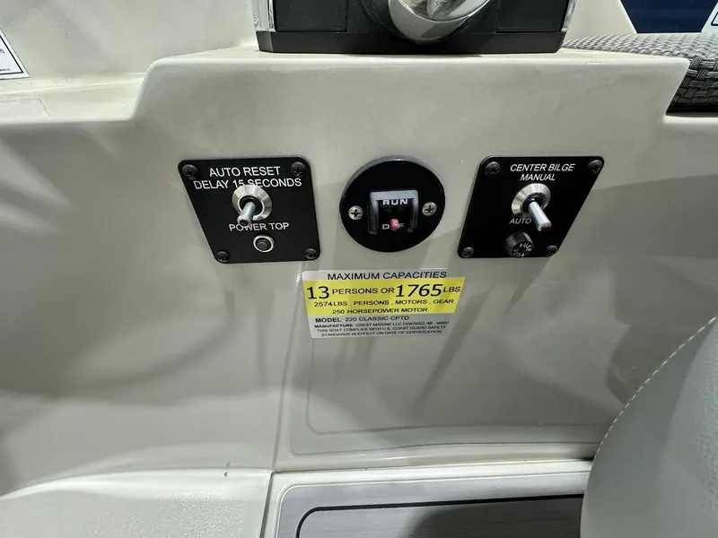 Slide: The Image of 2023 Crest Classic Platinum 220 control panel with auto reset and bilge switches. - 17