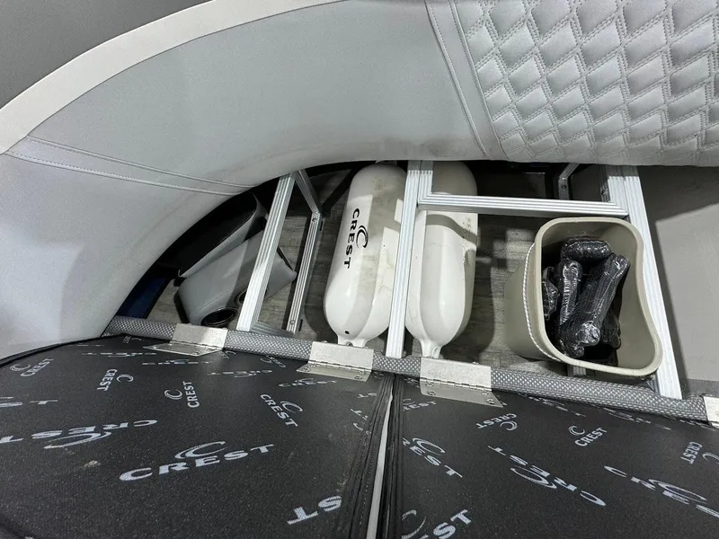 Slide: The Image of 2023 Crest Classic Platinum 220 boat storage compartment with fenders and accessories. - 19
