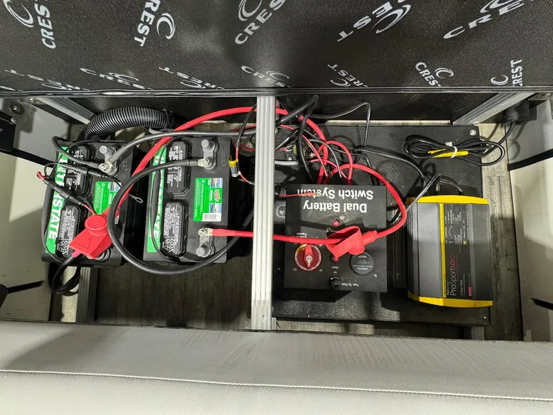 Slide: The Image of 2023 Crest Classic Platinum 220 battery compartment with dual battery switch system and wiring. - 20