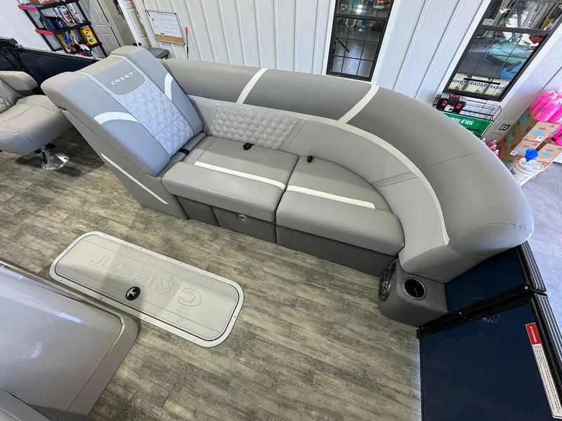 Slide: The Image of 2023 Crest Classic Platinum 220 boat interior with gray seating and modern design. - 6