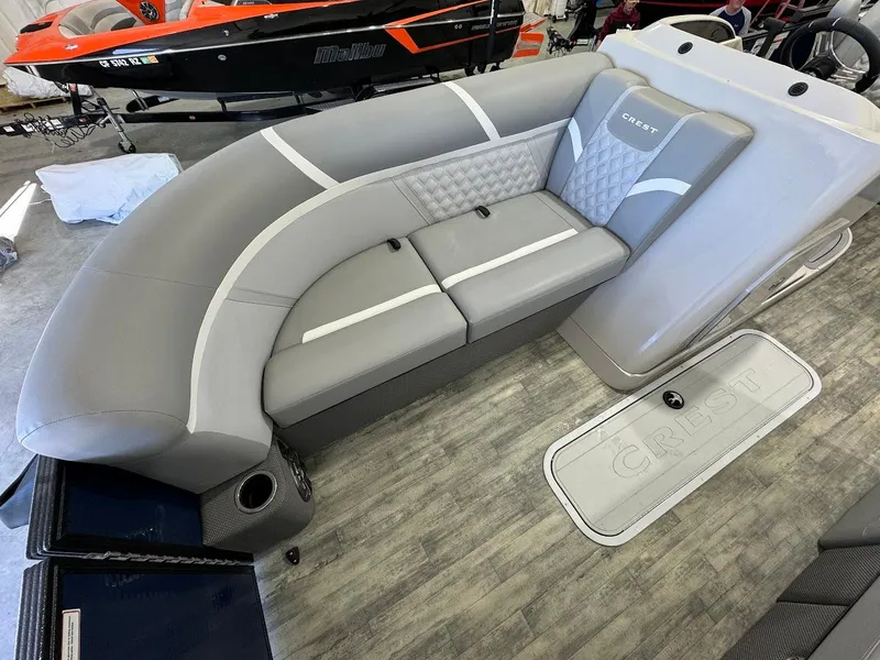 Slide: The Image of 2023 Crest Classic Platinum 220 boat interior with gray seating and modern design. - 7