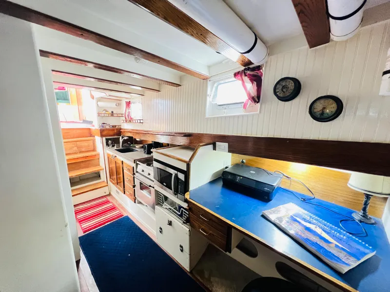 Slide: The Image of Interior of 1955 Colin Archer 42 sailboat with kitchen and workspace. - 21