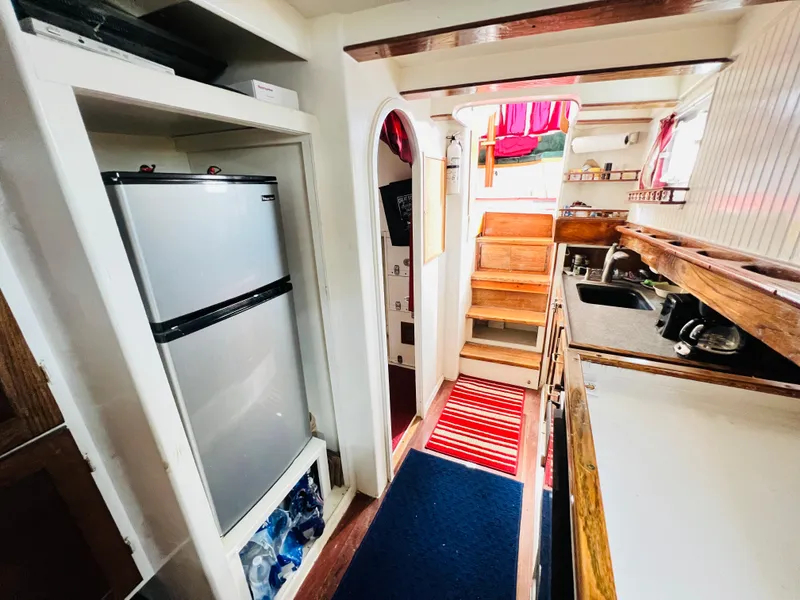 Slide: The Image of Interior of a 1955 Colin Archer 42 sailboat with kitchen and stairs. - 22