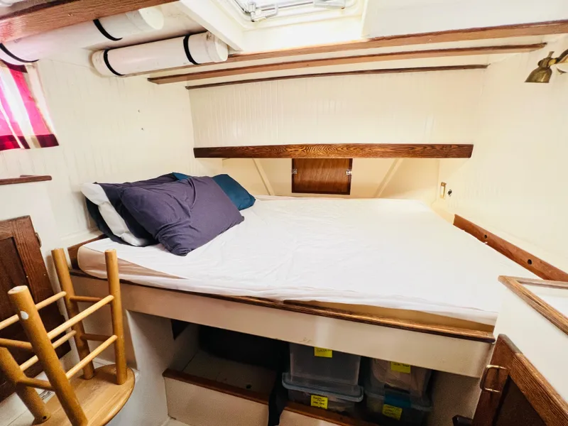 Slide: The Image of Cozy cabin bedroom in a 1955 Colin Archer 42 sailboat with wooden accents. - 26
