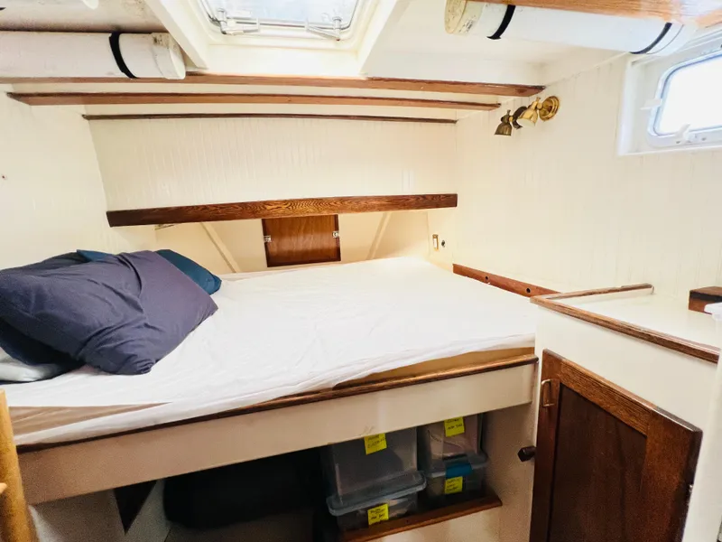 Slide: The Image of Cozy cabin bedroom in a 1955 Colin Archer 42 sailboat with wooden accents. - 27