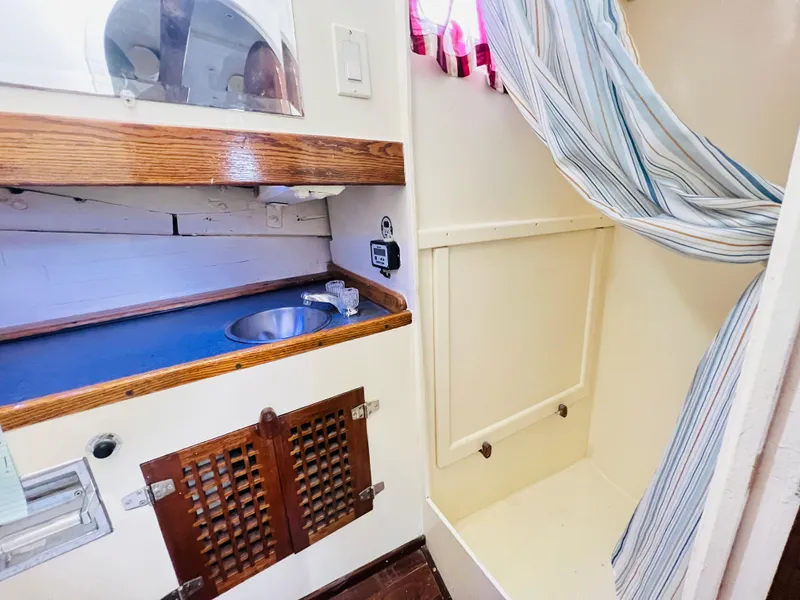 Slide: The Image of 1955 Colin Archer 42 boat interior with sink and shower area. - 33