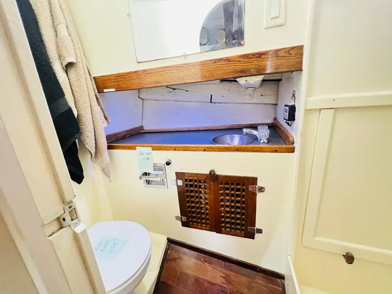 Slide: The Image of 1955 Colin Archer 42 boat bathroom with wooden accents and compact design. - 34