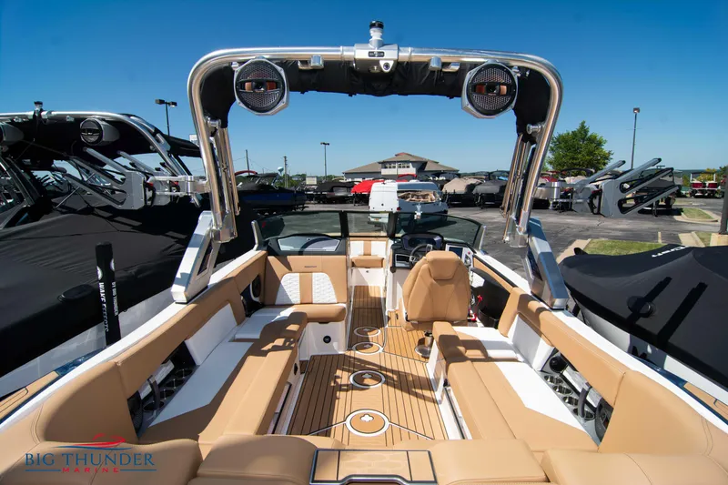 Slide: The Image of 2023 MasterCraft X24 boat interior with tan seating and advanced sound system. - 13