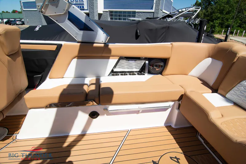 Slide: The Image of 2023 MasterCraft X24 boat interior with tan and white seating. - 17