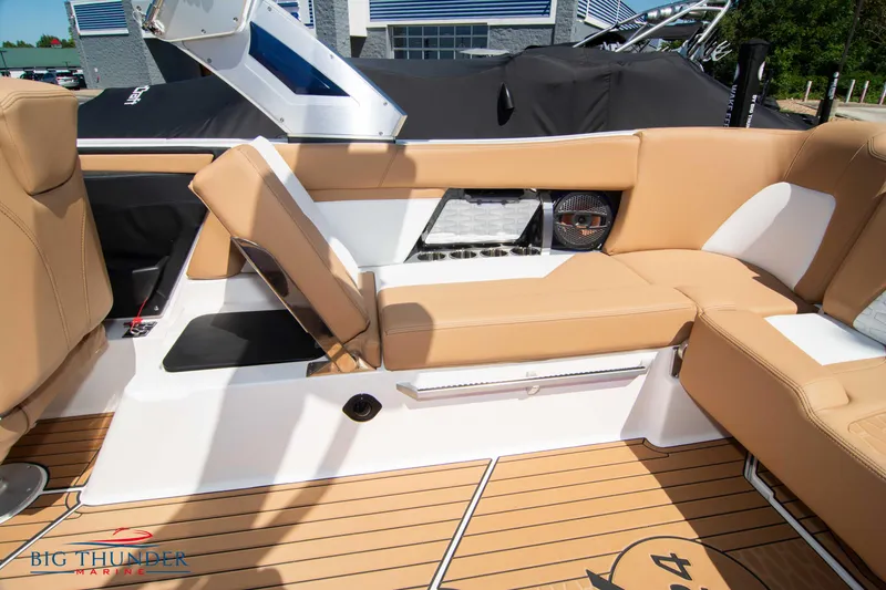 Slide: The Image of 2023 MasterCraft X24 boat interior with tan seating and teak flooring. - 18