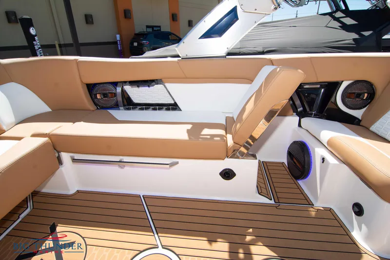 Slide: The Image of 2023 MasterCraft X24 boat interior with tan seating and teak flooring. - 20
