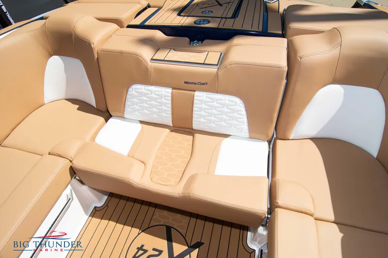 Slide: The Image of 2023 MasterCraft X24 boat interior with tan and white seating. - 28