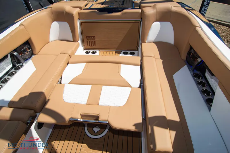 Slide: The Image of 2023 MasterCraft X24 boat interior with tan and white seating. - 30