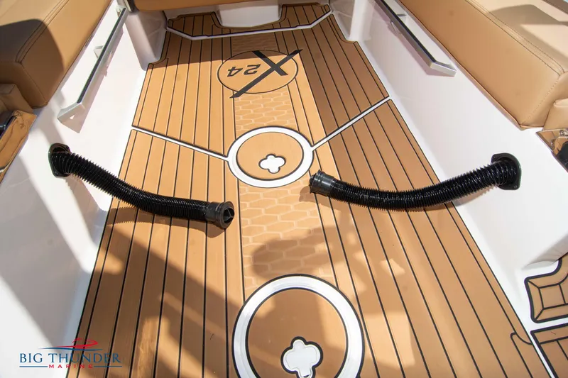 Slide: The Image of 2023 MasterCraft X24 boat interior with teak flooring and Big Thunder Marine logo. - 31