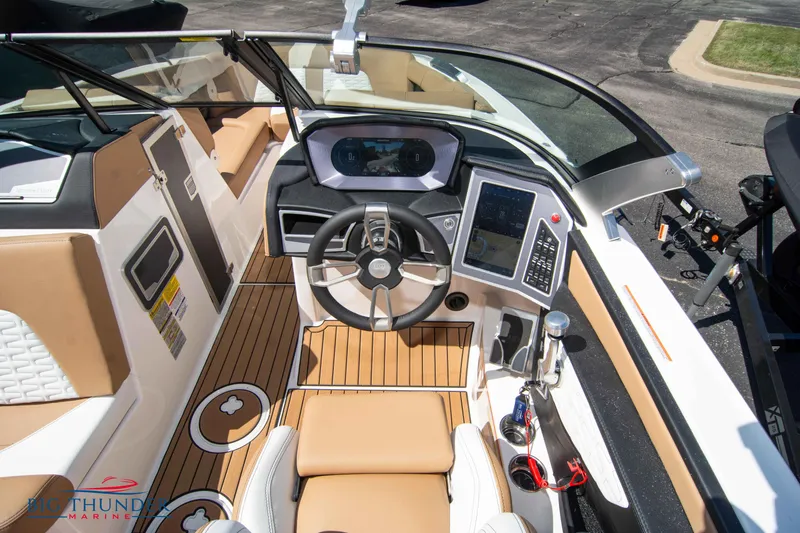 Slide: The Image of 2023 MasterCraft X24 boat cockpit with modern controls and luxurious seating. - 32