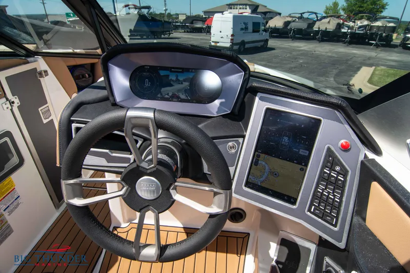 Slide: The Image of 2023 MasterCraft X24 boat dashboard with steering wheel and touchscreen controls. - 34