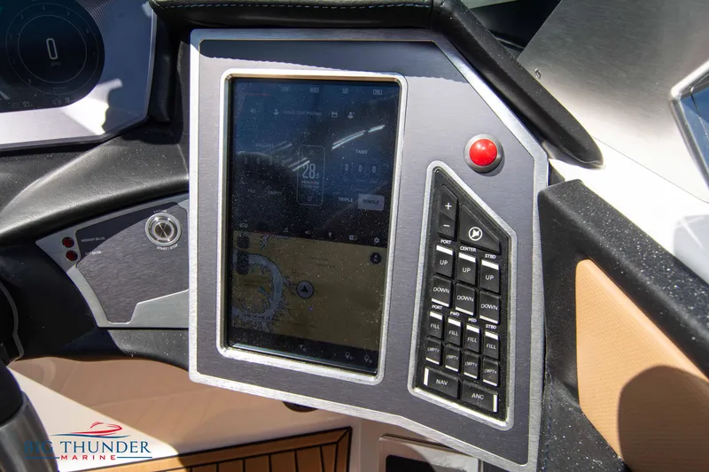 Slide: The Image of 2023 MasterCraft X24 boat dashboard with touchscreen and control panel. - 36