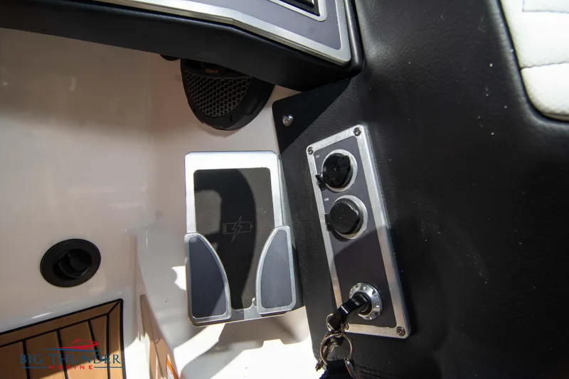 Slide: The Image of 2023 MasterCraft X24 boat dashboard controls and foot pedal. - 37