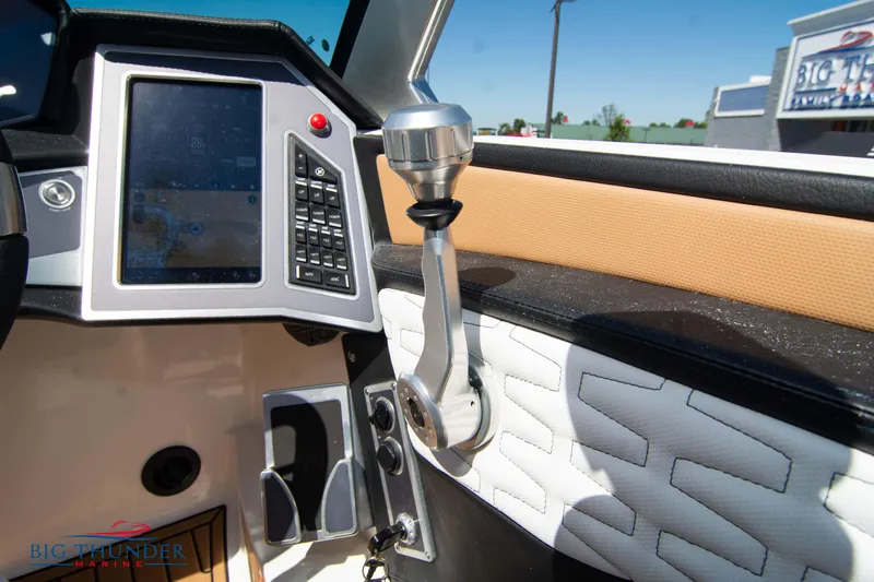 Slide: The Image of 2023 MasterCraft X24 boat dashboard with touchscreen and control lever. - 38