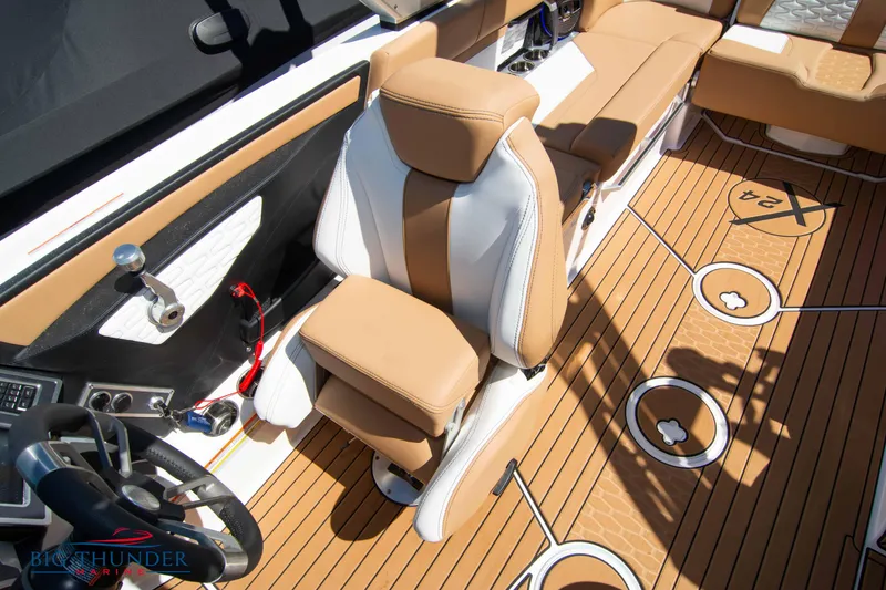 Slide: The Image of 2023 MasterCraft X24 boat interior with tan and white seating and teak flooring. - 41