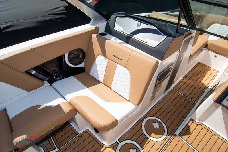 Slide: The Image of 2023 MasterCraft X24 boat interior with tan and white seating, teak flooring. - 42