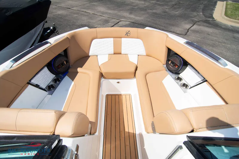 Slide: The Image of 2023 MasterCraft X24 boat interior with tan seating and premium sound system. - 46