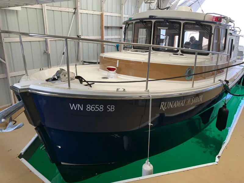 Slide: The Image of 2014 Ranger Tugs Trawler boat docked in a covered marina. - 1
