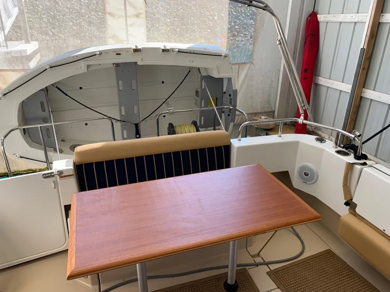 Slide: The Image of 2014 Ranger Tugs Trawler interior with wooden table and seating. - 10