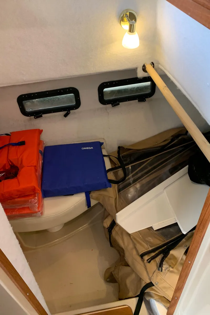 Slide: The Image of 2014 Ranger Tugs Trawler interior storage area with life jackets and supplies. - 14