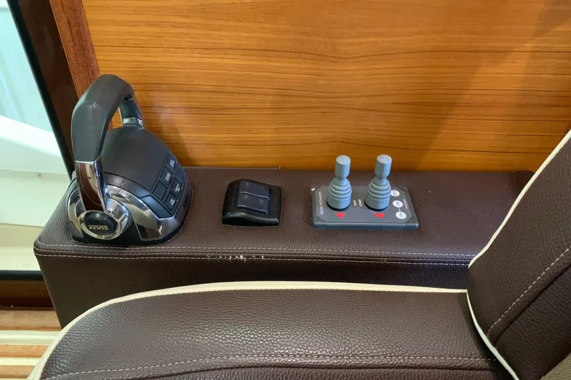 Slide: The Image of 2014 Ranger Tugs Trawler control panel with throttle and joystick controls. - 22